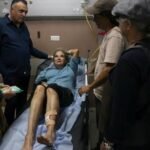 Israel detiene a 10 colonos tras el ataque a una fotógrafa del Washington Post Una mujer con una pierna vendada, tendida en una camilla de hospital, rodeada de varias personas
